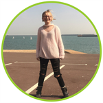 Tilly Moore, an arthritis patient at Evelina London, standing in front of the sea.