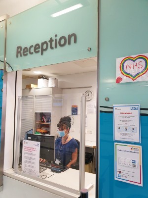 Our reception at Evelina London. A member of staff is wearing a face mask.