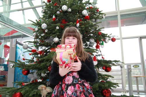 Hannah Robinson with gifts for other children at Christmas