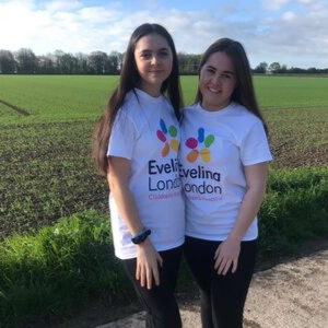 Amelia with her friend in the countryside wearing Evelina London t-shirts.
